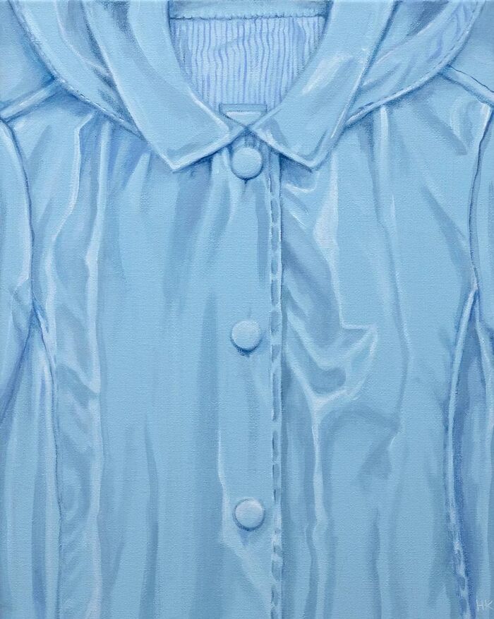 A light blue jumper with buttons, part of an artist's striking portrait series revealing identity through everyday clothes.