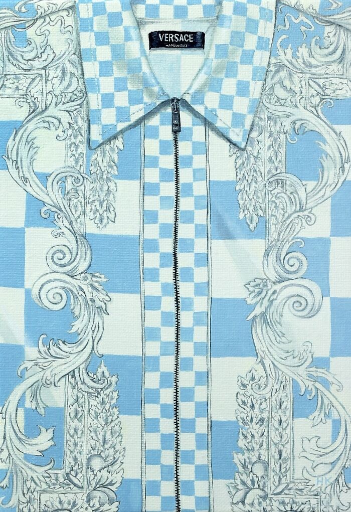 Artist painting of a blue and white patterned slogan t-shirt, forming striking portraits of identity through clothing.