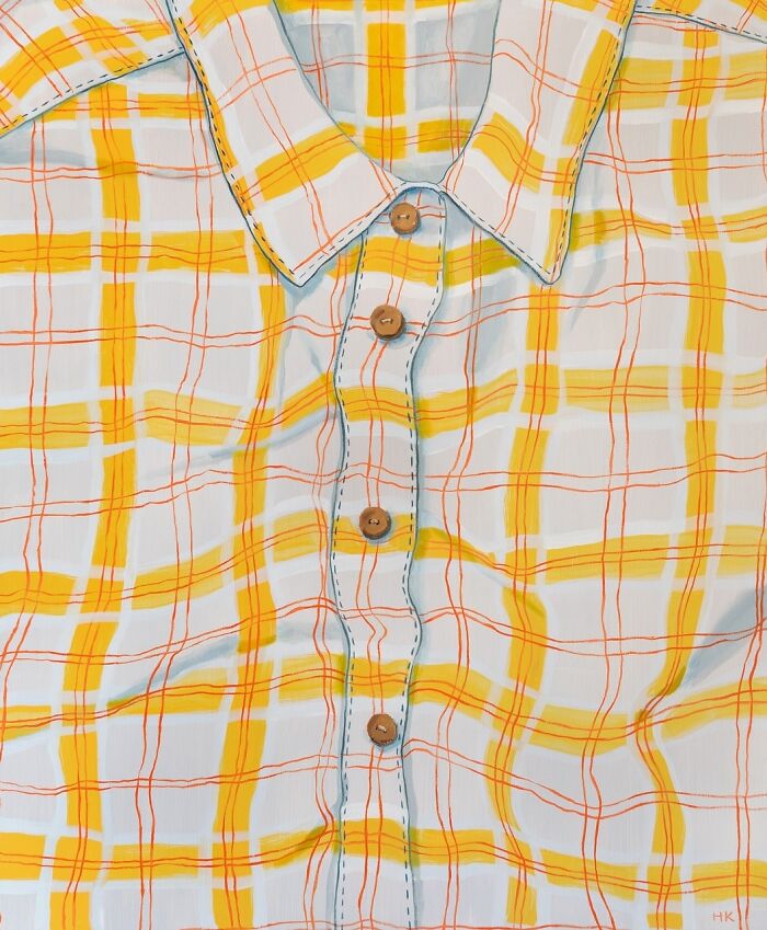 Striking portrait of identity: a white and yellow plaid shirt with distinct orange lines and wooden buttons.