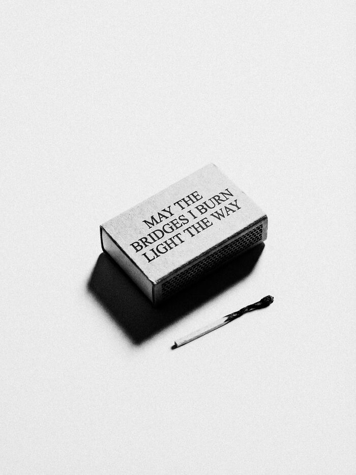 A matchbox with text and a burnt match, a surreal and dystopian image by Marcus Wallinder.
