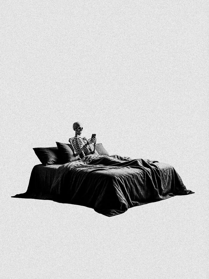 A skeleton in bed, looking at a phone, creating a surreal and dystopian image.