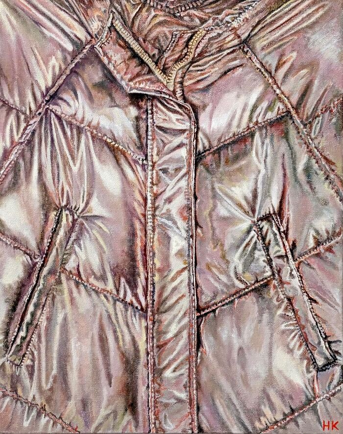 A striking portrait of identity featuring a shiny, quilted fur coat with pockets and a zipper, made by an artist.