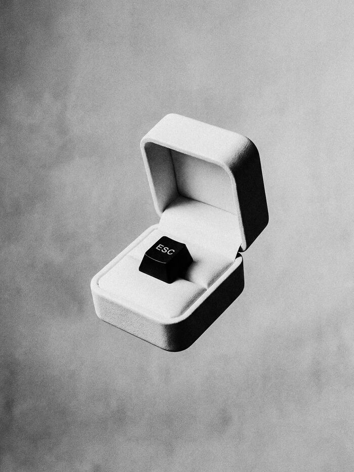 A black and white image of an ESC key in an open ring box, a dystopian image by Marcus Wallinder.