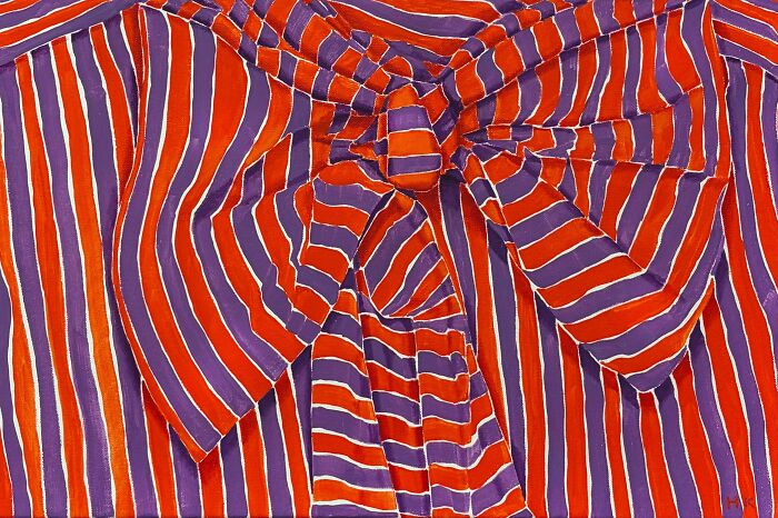 A vibrant painting of a striped shirt with a large bow, transformed by an artist into a striking portrait of identity.
