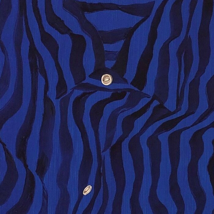 A striking portrait of identity featuring a blue striped shirt with a single visible button, emphasizing the pattern.