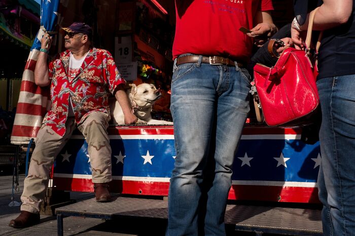 Jeffrey De Keyser's street photography features a dog on a patterned counter with people nearby.