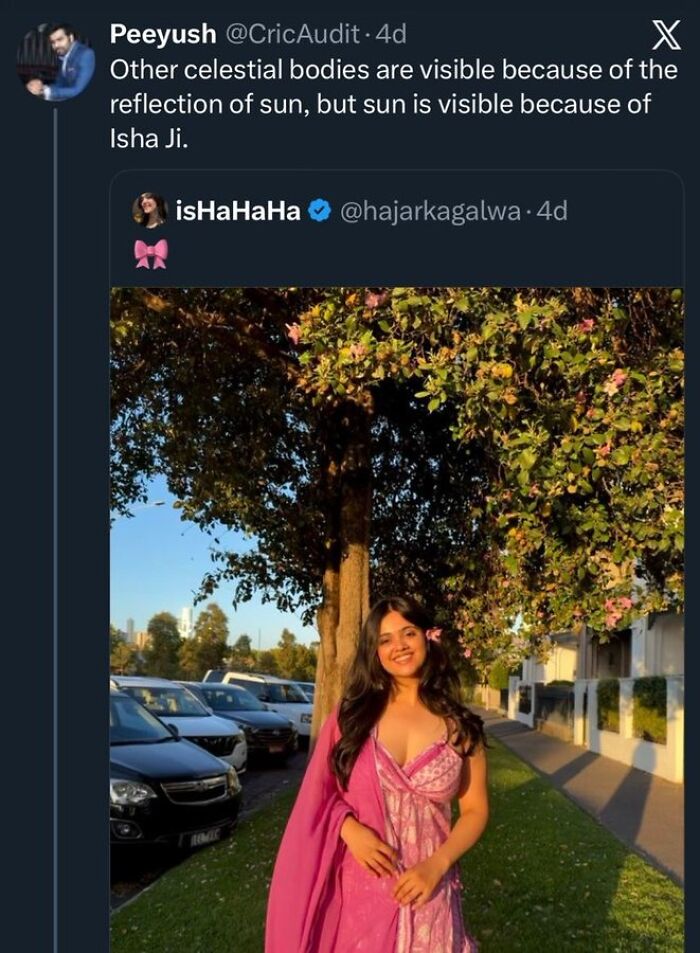 Woman in pink dress smiling under tree in golden hour light with starry-eyed lovers theme