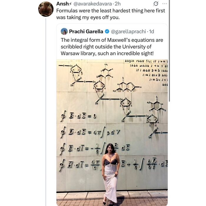 Woman posing in front of Maxwell's equations mural outside University of Warsaw library
