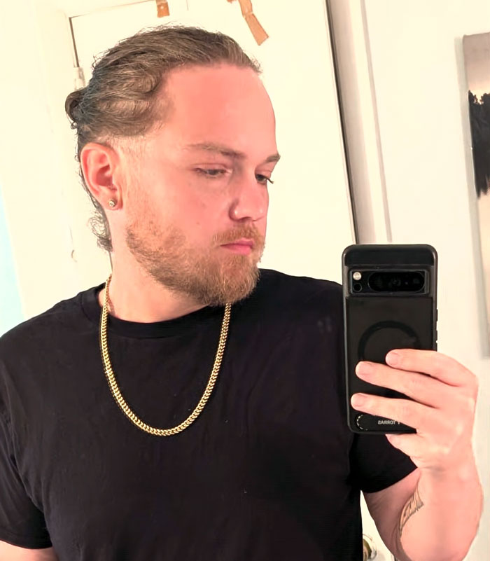 A man captures his incredible weight loss transformation, taking a mirror selfie, showing a more defined face and wearing a black t-shirt. A man captures his incredible weight loss transformation, taking a mirror selfie, showing a more defined face and wearing a black t-shirt.