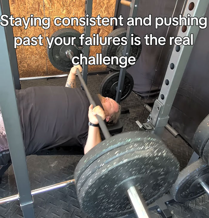 A man performs a bench press in a gym with the text: Staying consistent and pushing past your failures is the real challenge. A key step in weight loss. A man performs a bench press in a gym with the text: Staying consistent and pushing past your failures is the real challenge. A key step in weight loss.