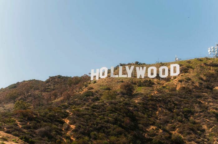 The iconic Hollywood sign on a sunny hill, representing industries that are about to collapse.