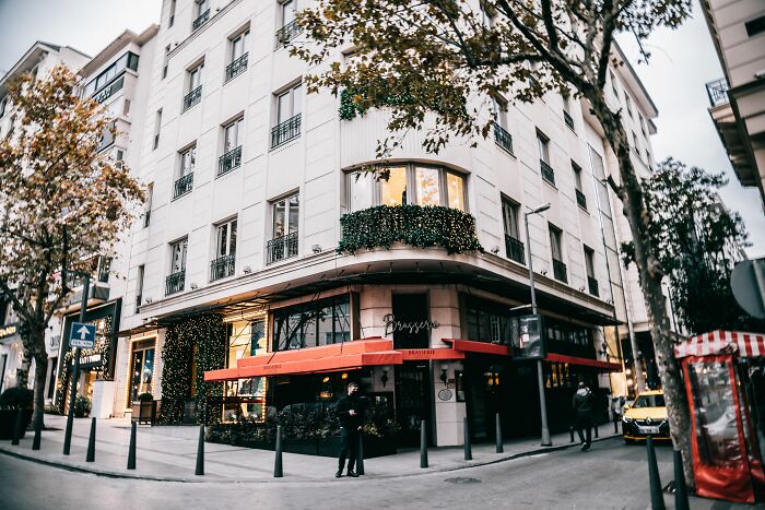 A charming building corner with a cafe, illustrating industries that are about to collapse.