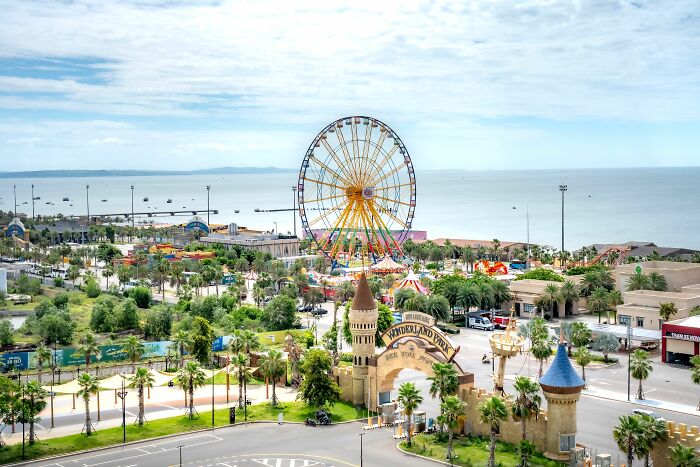 Amusement park by the sea with a Ferris wheel, an industry about to collapse.