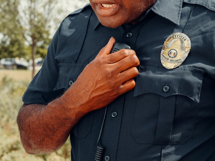 Security guard with a badge and radio, representing industries about to collapse.