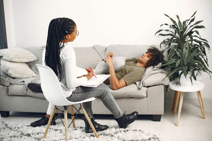 A therapist talking to a client on a couch, illustrating a changing industry.
