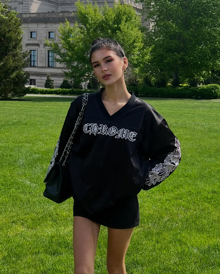 A young woman standing in a park, related to looksmaxxing influencer Clavicular. A young woman standing in a park, related to looksmaxxing influencer Clavicular.