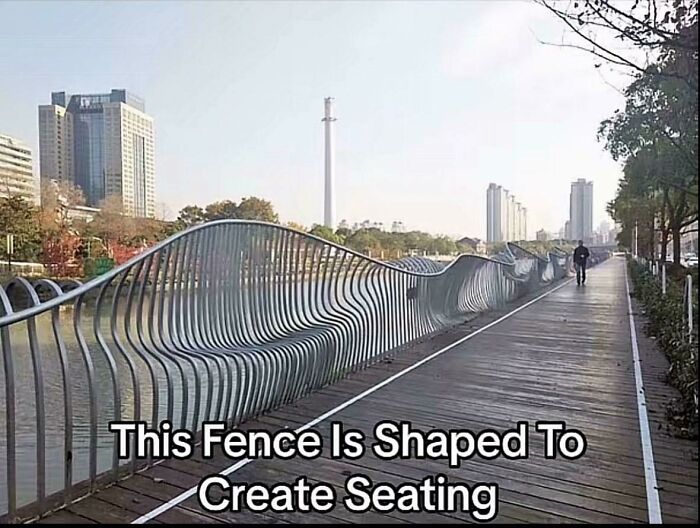 Wavy fence design creates integrated seating on a city pathway