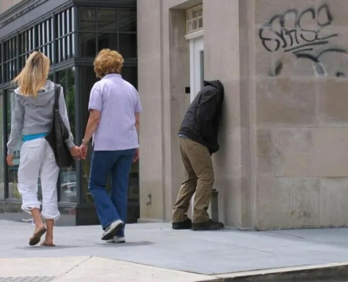 A person with their head against a wall, perfectly synced to the angle, showcasing amazing times.
