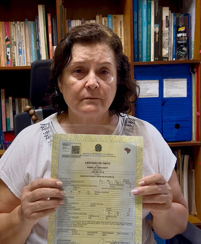 A grieving mother holding her daughter's d***h certificate A grieving mother holding her daughter's d***h certificate