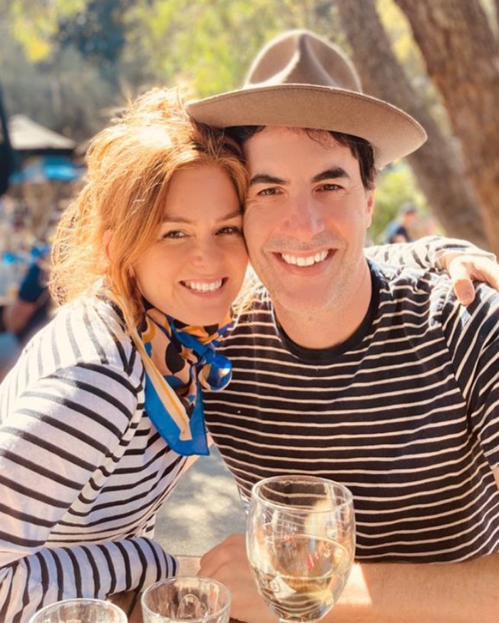 Isla Fisher and her ex-husband smiling together outdoors, discussing dating ick after divorce.