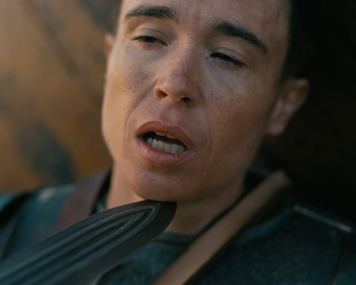 Elliot Page in a dramatic movie scene with a blade held to his neck Elliot Page in a dramatic movie scene with a blade held to his neck