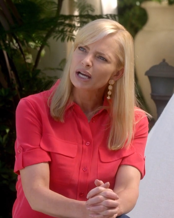 Hollywood actress in a red shirt, hands clasped, looking concerned, likely discussing the hotel meltdown incident. Hollywood actress in a red shirt, hands clasped, looking concerned, likely discussing the hotel meltdown incident.