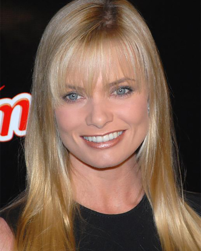 Close-up of a blonde Hollywood actress with a fringe and blue eyes, smiling, after a hotel meltdown. Close-up of a blonde Hollywood actress with a fringe and blue eyes, smiling, after a hotel meltdown.