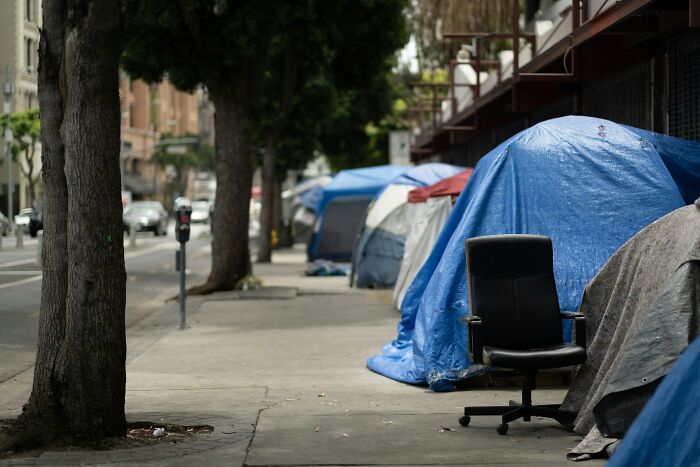 Tents on a city sidewalk representing the harsh reality of being unemployed.