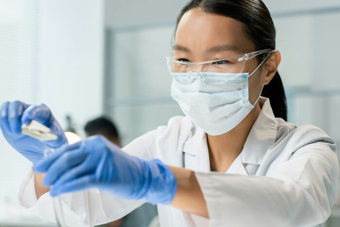 A scientist working in a lab, highlighting the demand for specialized skills in a shifting job market