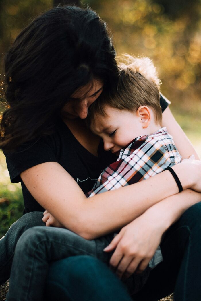 Mother hugging her crying child, showing what children were going through and parents opening up.