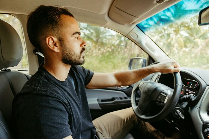 A man driving a car, representing actions people do that others judge.