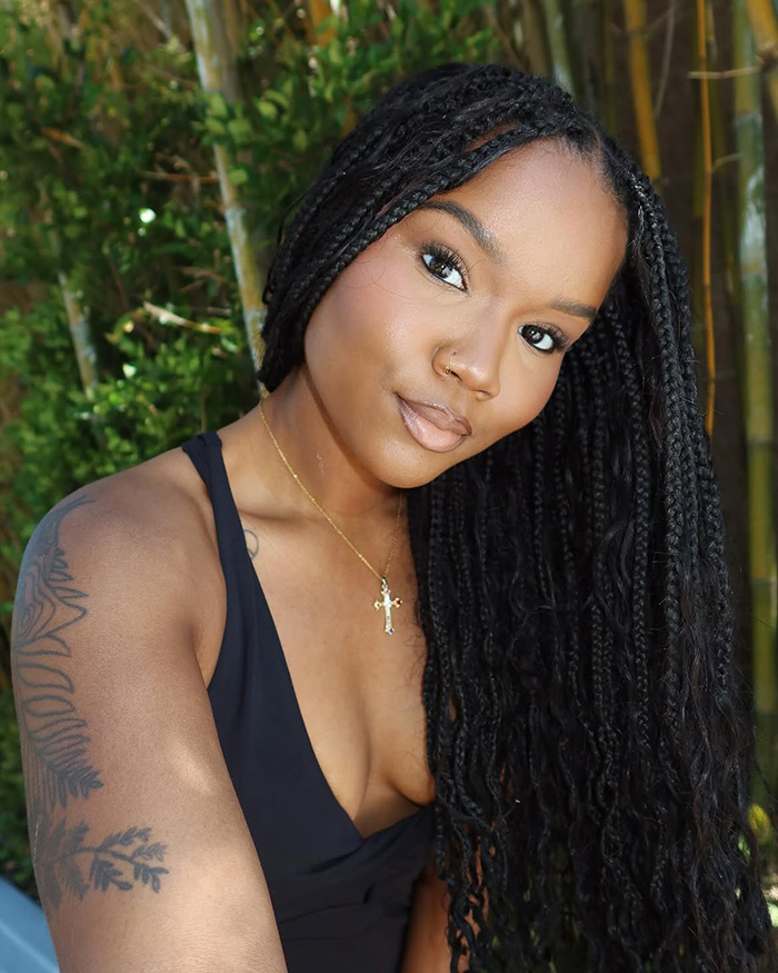 Portrait of black woman with long braided hair outdoors Portrait of black woman with long braided hair outdoors