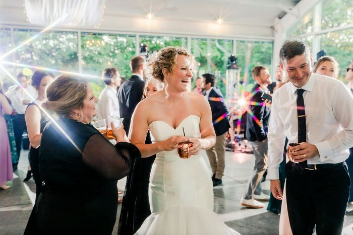 A happy bride laughing during her wedding reception, showcasing weddings and romance