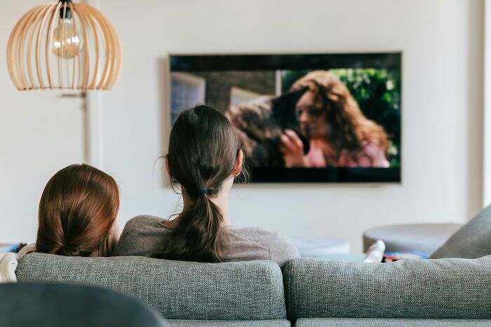 Two people watching television together, emphasizing the importance of clear vision