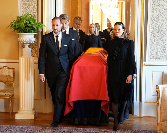 Members of Norway's royal family at a royal funeral, carrying a coffin. Son of Norway's Crown attends.