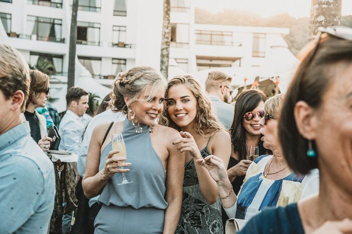 Two women smiling at a social event, navigating complex family relationships after going no contact with a parent.
