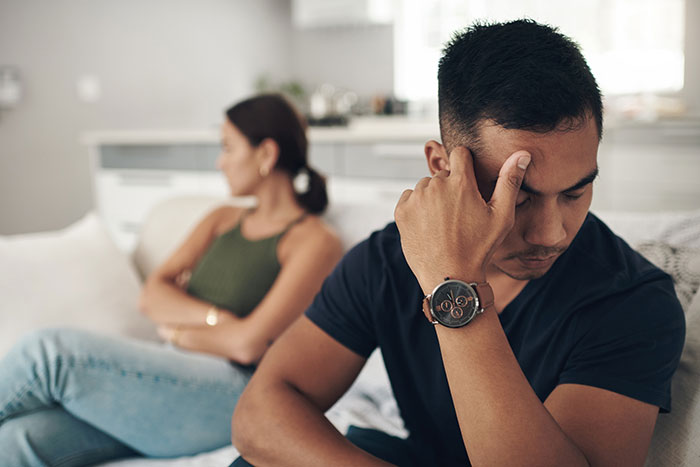 A man looking stressed with his girlfriend in the background. She refused to drive home drunk women who insulted her. A man looking stressed with his girlfriend in the background. She refused to drive home drunk women who insulted her.