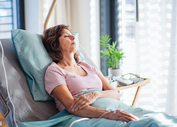 Sick mother resting in hospital bed