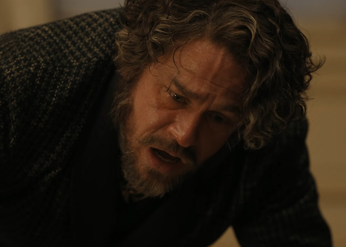 Man with curly hair looking shocked on the floor in Lizzie Borden series scene Man with curly hair looking shocked on the floor in Lizzie Borden series scene