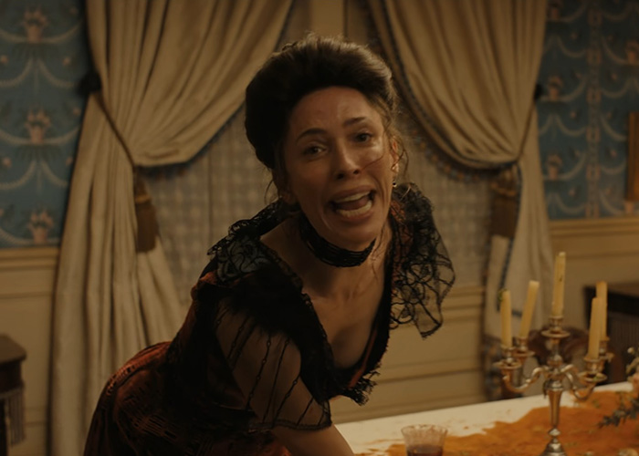Distressed woman in period costume yelling at dining table in Lizzie Borden series Distressed woman in period costume yelling at dining table in Lizzie Borden series