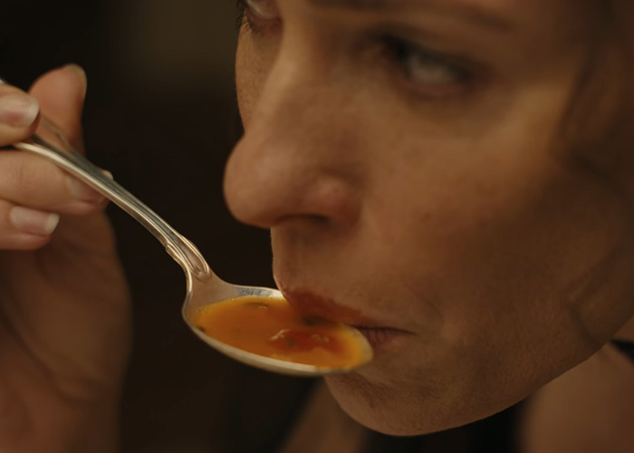Close-up of woman tasting soup in Lizzie Borden series disturbing scene Close-up of woman tasting soup in Lizzie Borden series disturbing scene