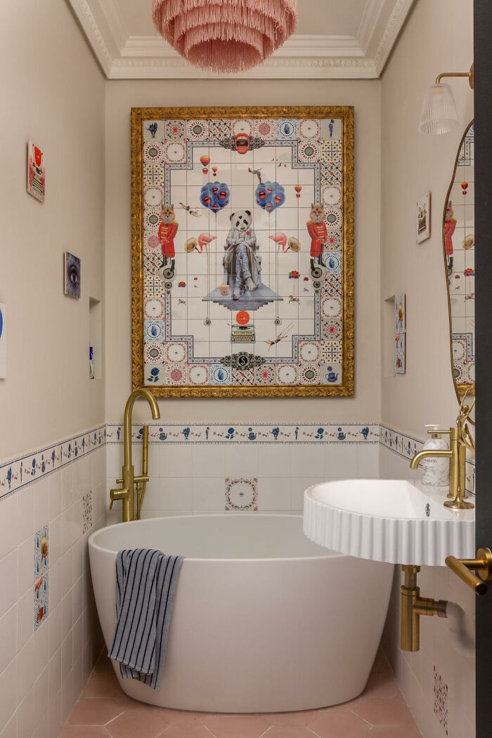 Bathroom with artistic tile works featuring surreal animal and object motifs framed with gold