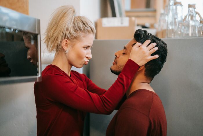 A woman playfully grabs a man's face, illustrating moments in a marriage that has lasted over 20 years.