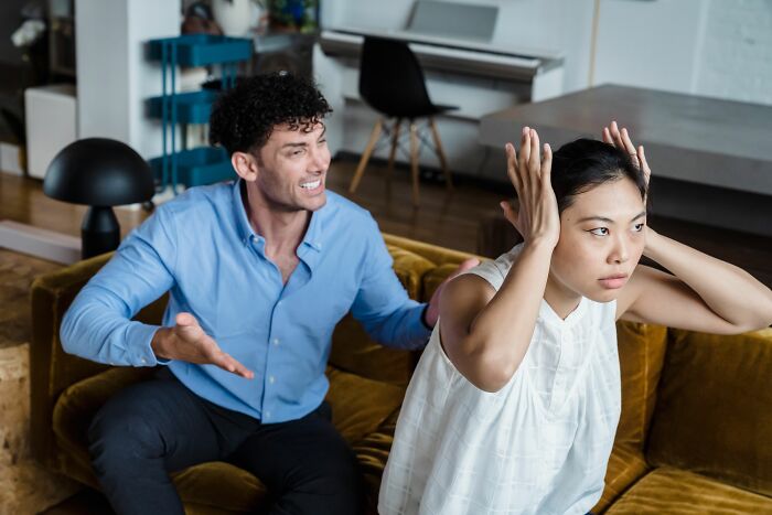 A man arguing with a woman who covers her ears, illustrating conflict after years in a marriage.