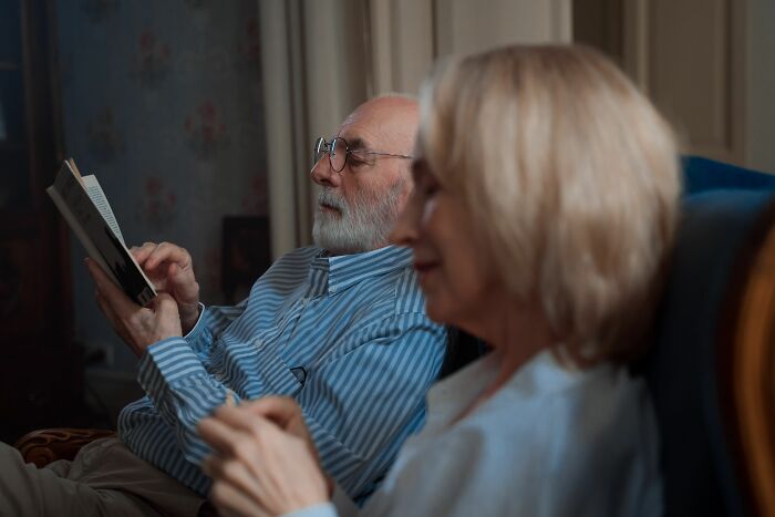An elderly couple reading together, representing enduring companionship and a long-term marriage.