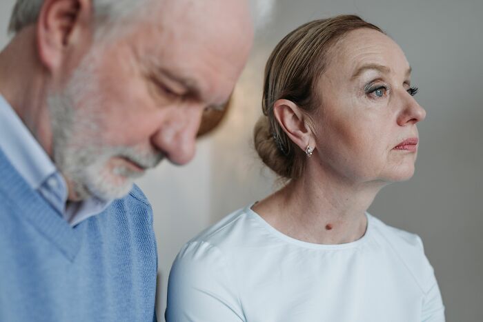 An older couple with a pensive expression, showing a change in their long-lasting marriage.