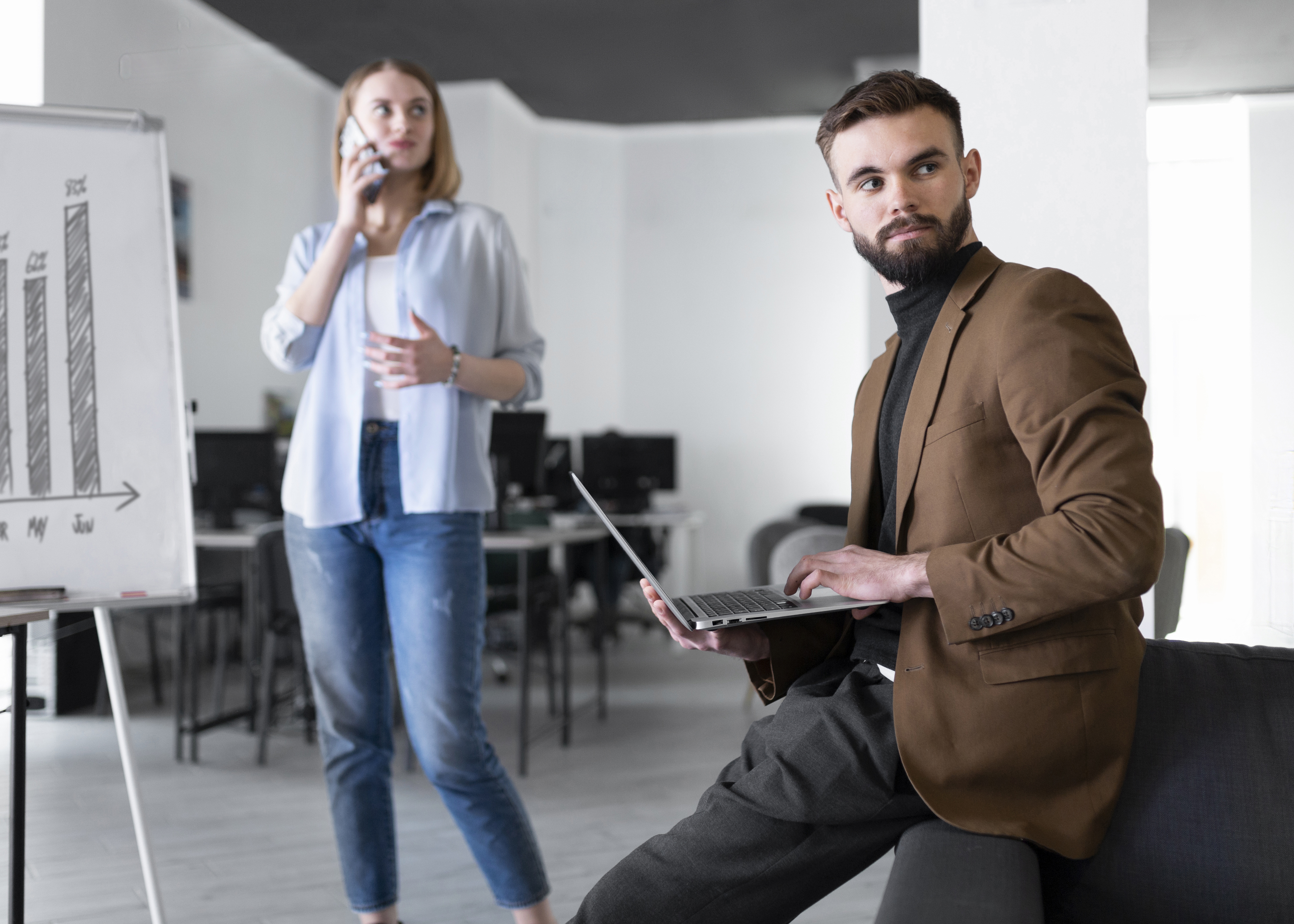 Male mentor and female colleague discussing work in an office setting. Male mentor and female colleague discussing work in an office setting.