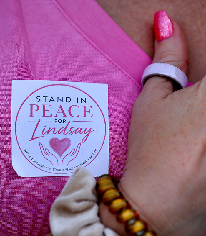 A person wears a pin saying Stand In Peace for Lindsay, relating to the Lindsay Clancy case and the called off wedding. A person wears a pin saying Stand In Peace for Lindsay, relating to the Lindsay Clancy case and the called off wedding.