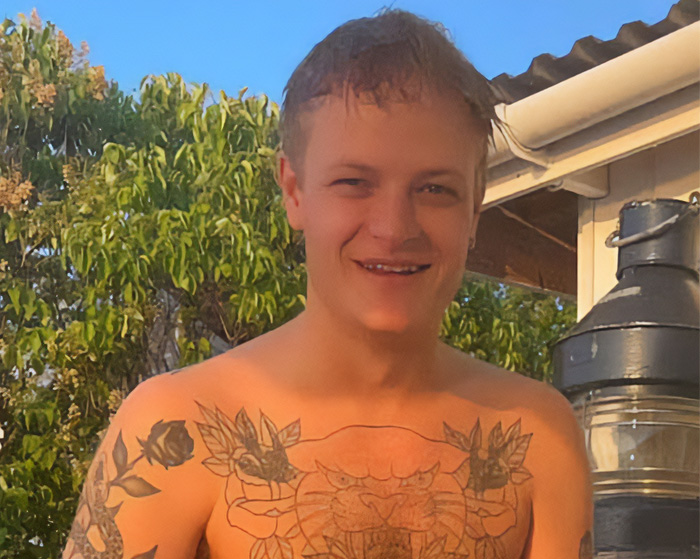 Son of Norway's Crown with tattoos. He is smiling while attending a royal funeral with a crucial role.