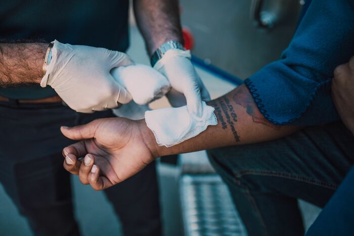 Medical workers bandaging a patient's arm